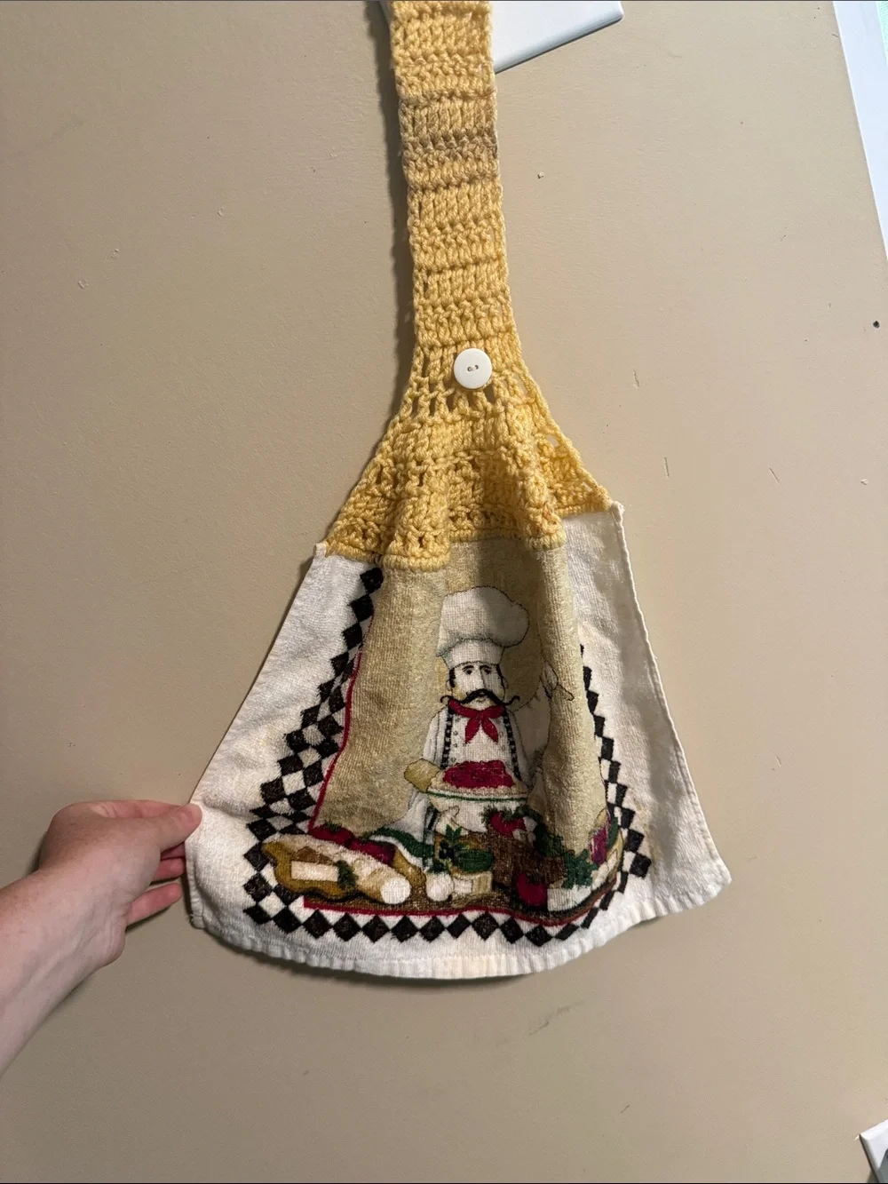 Vintage handmade yellow-topped crochet hanging kitchen towel featuring a chef